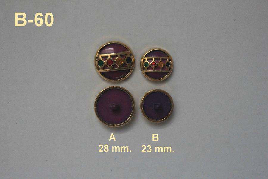 Botón joya dorado con fondo morado y cristales de colores
